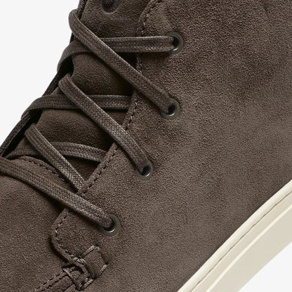 Dark gray suede chukka boot with black laces and cream-colored sole, shown from side detail.